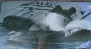 “Silverstrand Jetty at sunset with waves breaking against the rocks, inspired by the historic shipwreck that formed its foundation.”