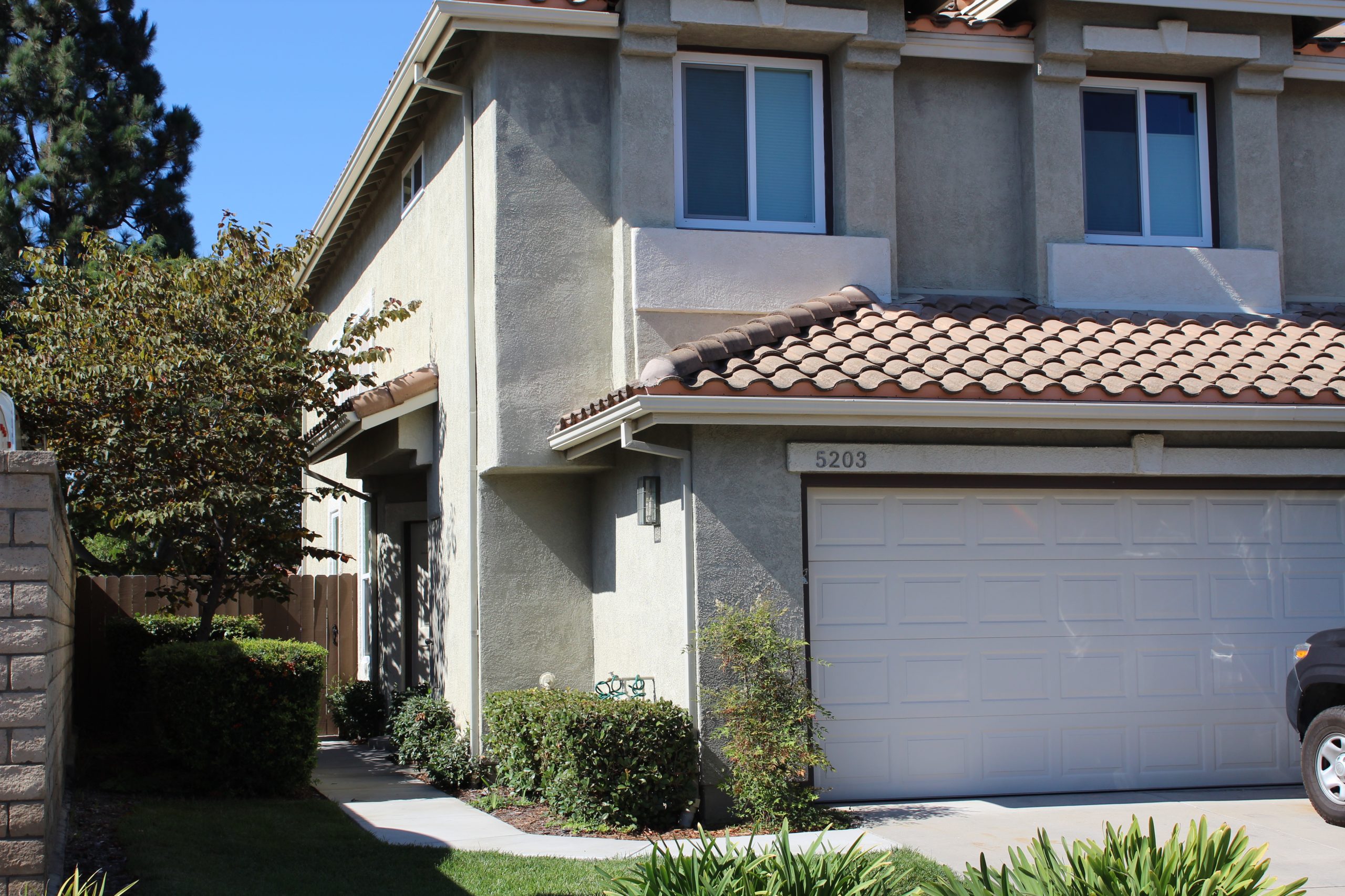 Two‑story corner‑lot home in the Creekside subdivision of Mission Oaks, Camarillo, featuring a tile roof, three‑car garage, landscaped front yard, and mature tree. Photo taken by Diane Schweers.