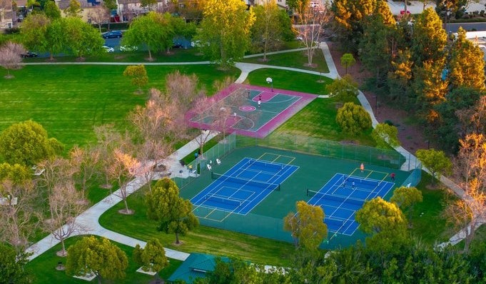 Aerial view of Pitts Park in Camarillo featuring tennis courts, a basketball court, walking paths, and surrounding green space.