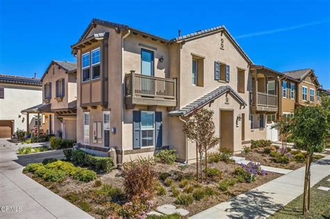 Row of well‑maintained Mission Oaks townhomes with clean landscaping on a sunny day.